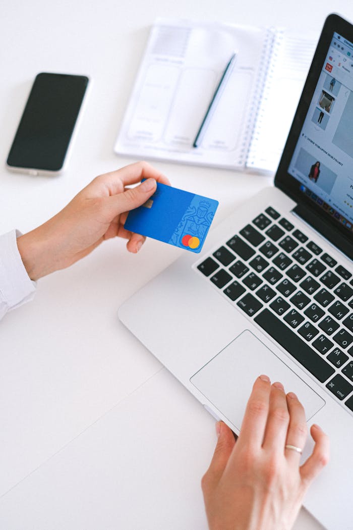 gallery-01 Person making an online purchase with a credit card on a laptop, showcasing modern ecommerce technology.